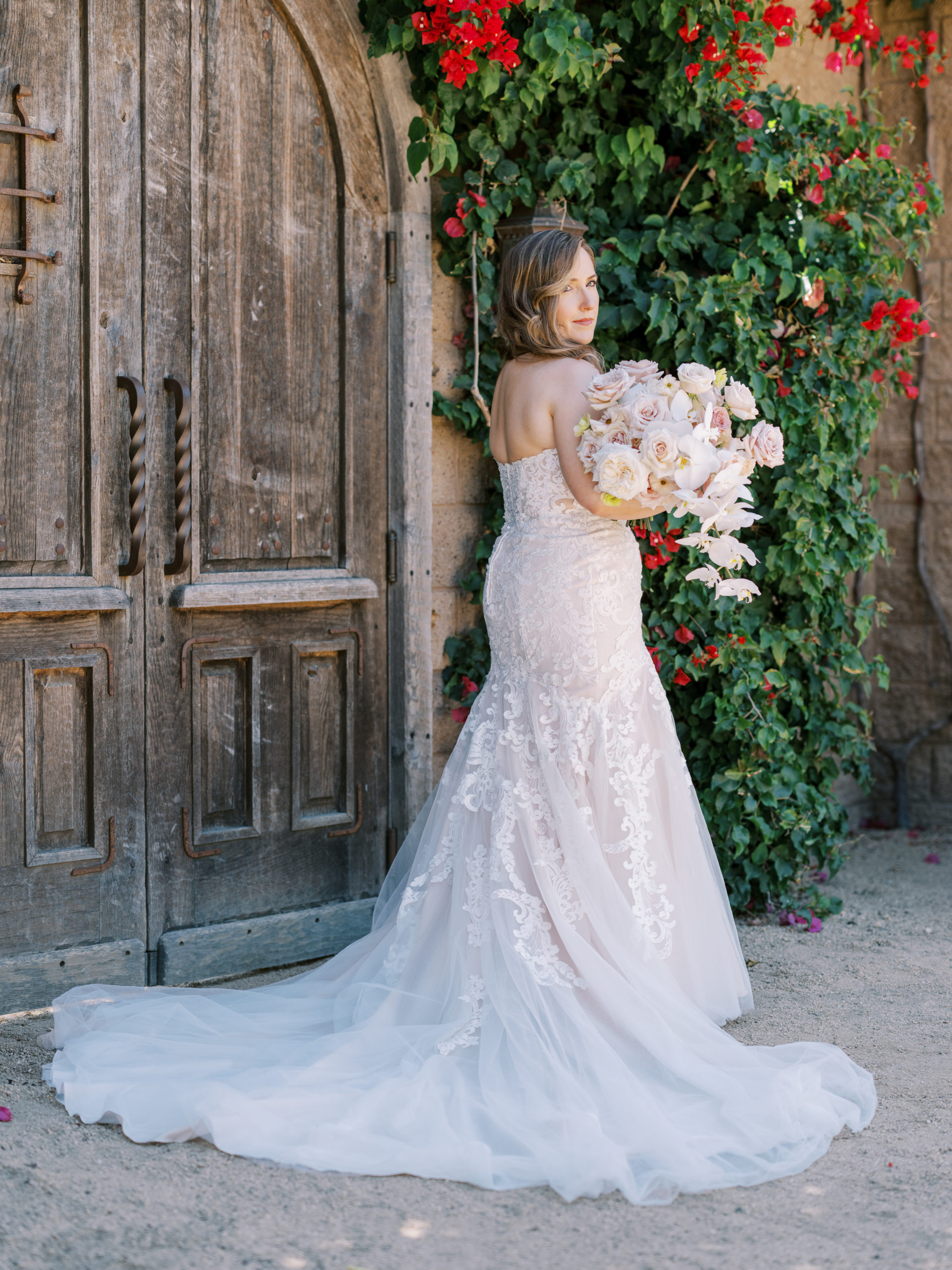 Catalina View Gardens Wedding - The bride stands with the bougainvillea