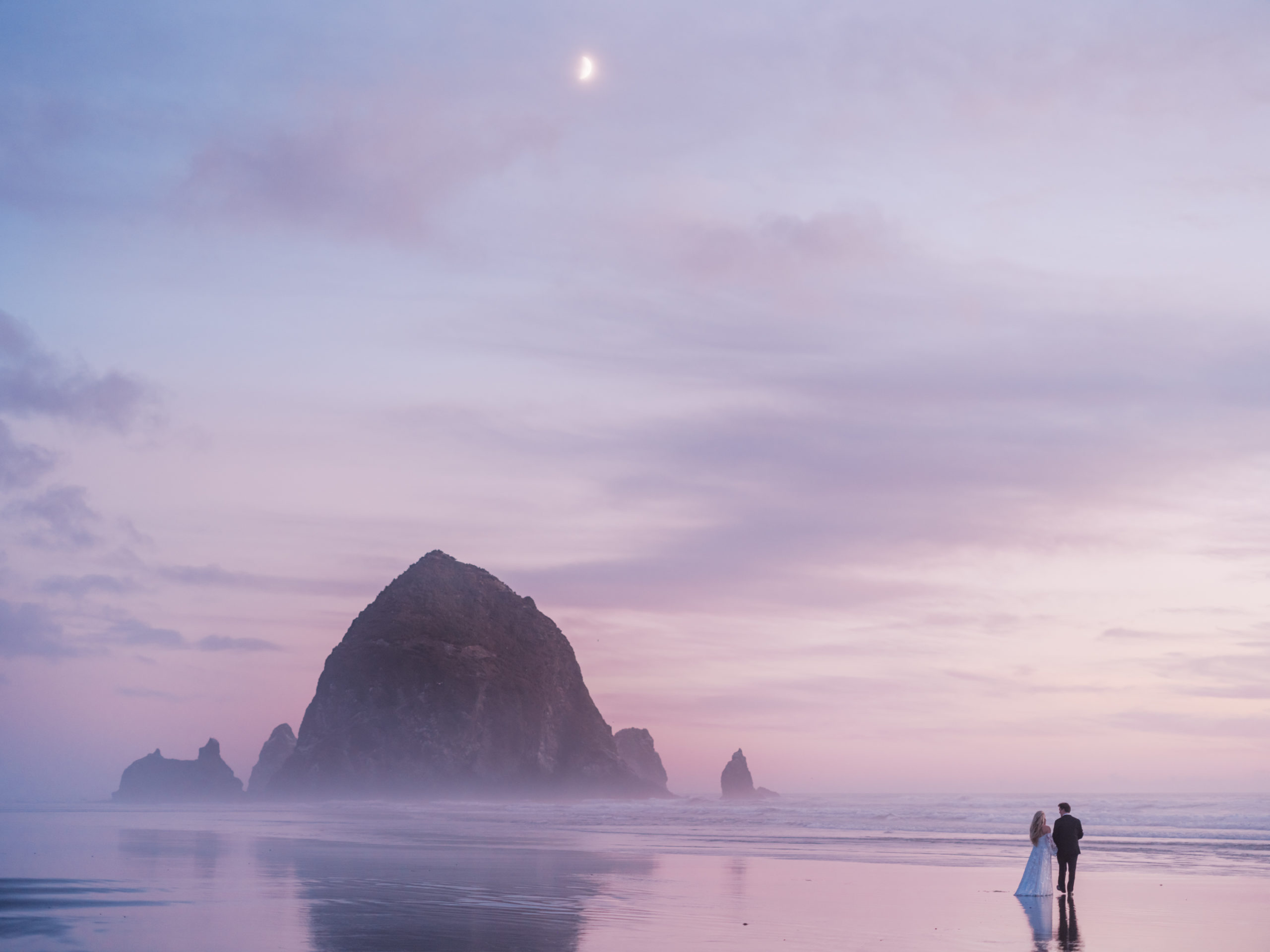 Cannon Beach Wedding - Bride and Groom at Sunset Haystack Rock with Moon by Mirelle Carmichael Fine Art Photography fujifilm gfx100s 1