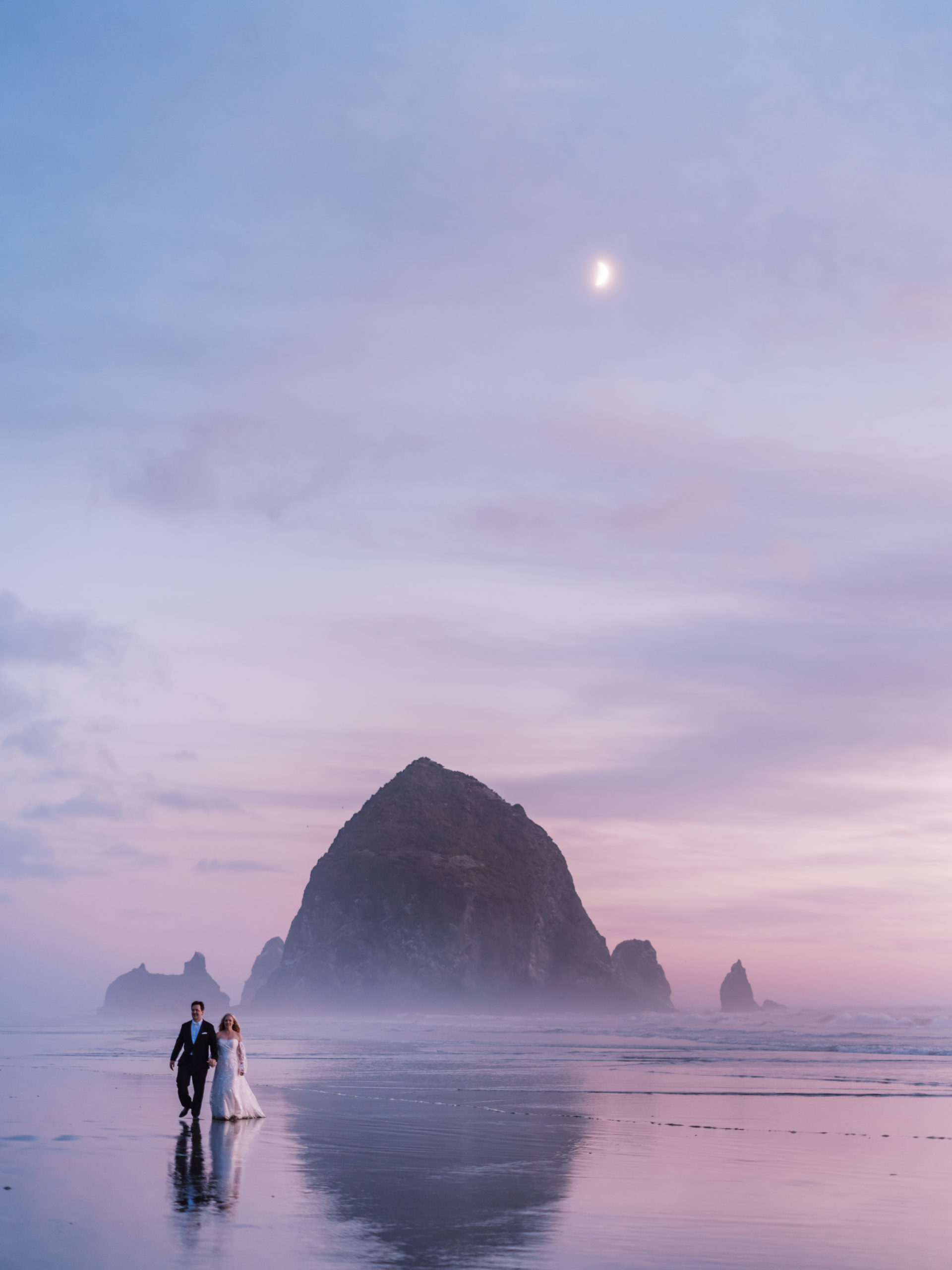 Cannon Beach Wedding - Bride and Groom at Sunset Haystack Rock with Moon by Mirelle Carmichael Fine Art Photography fujifilm gfx100s 3