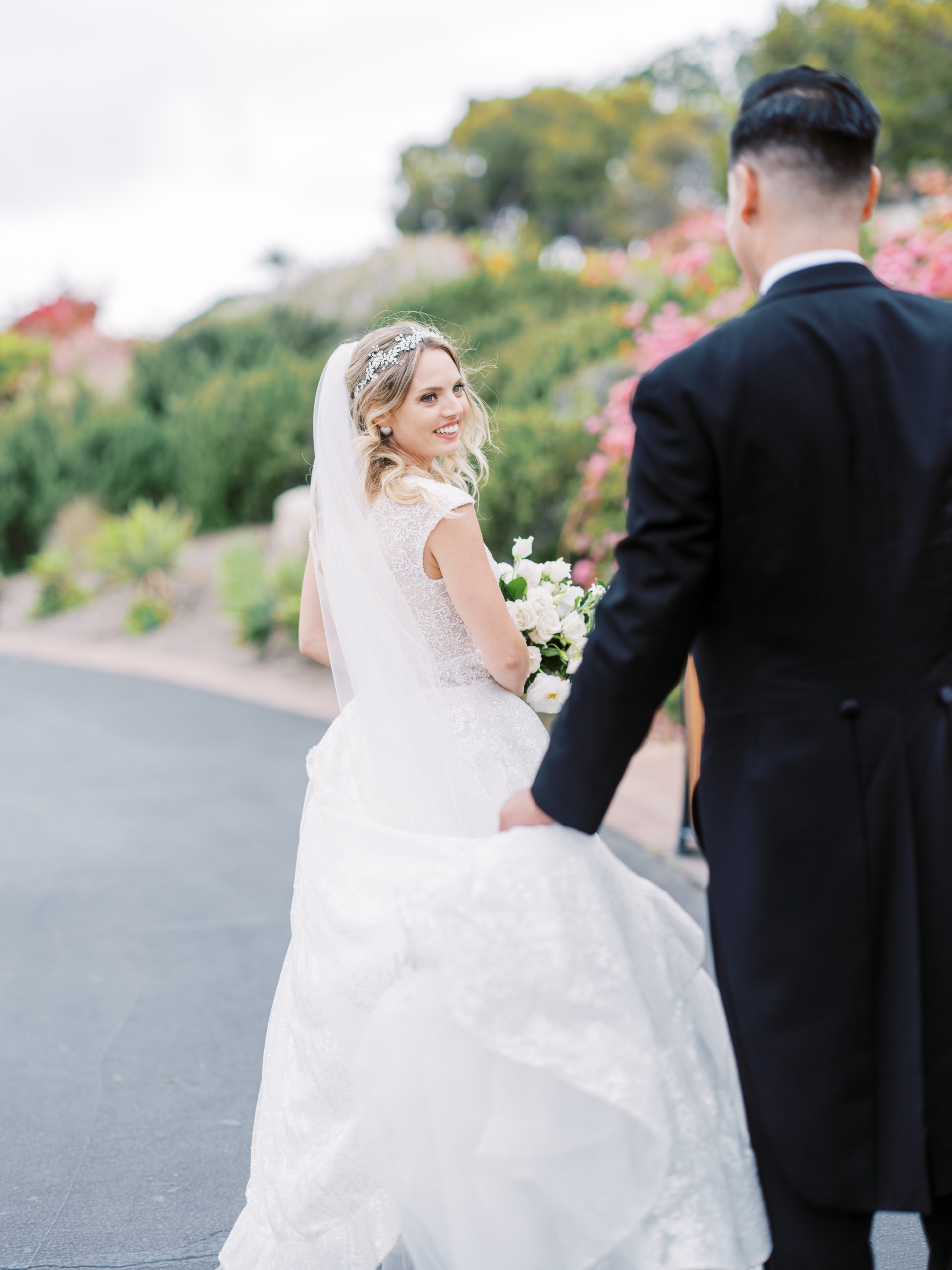 Terranea wedding groom helps bride with gown
