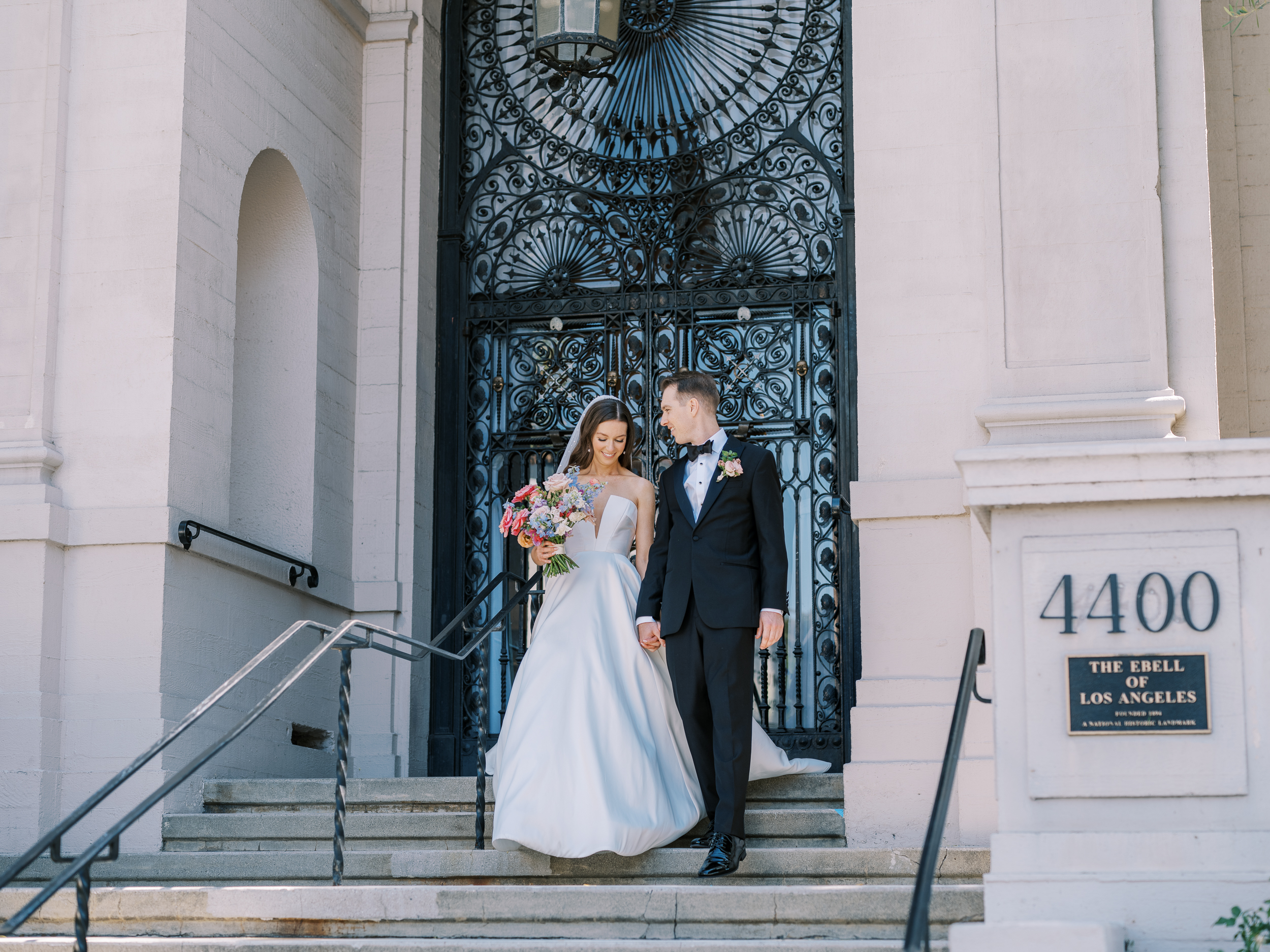 ebell los angeles wedding 2022 bride and groom on steps at entrance