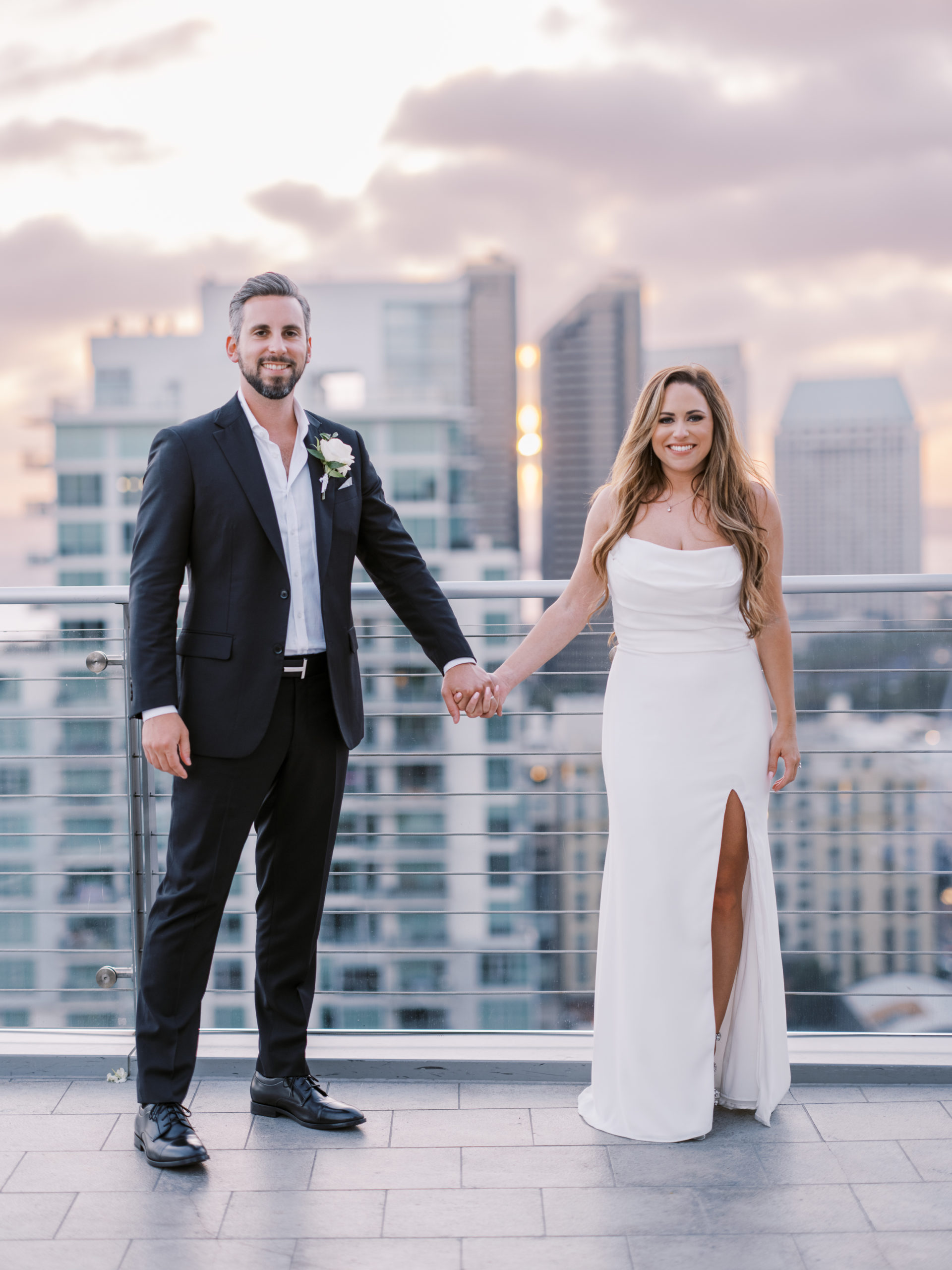 ultimate skybox wedding at diamondview tower - bride and groom holding hands