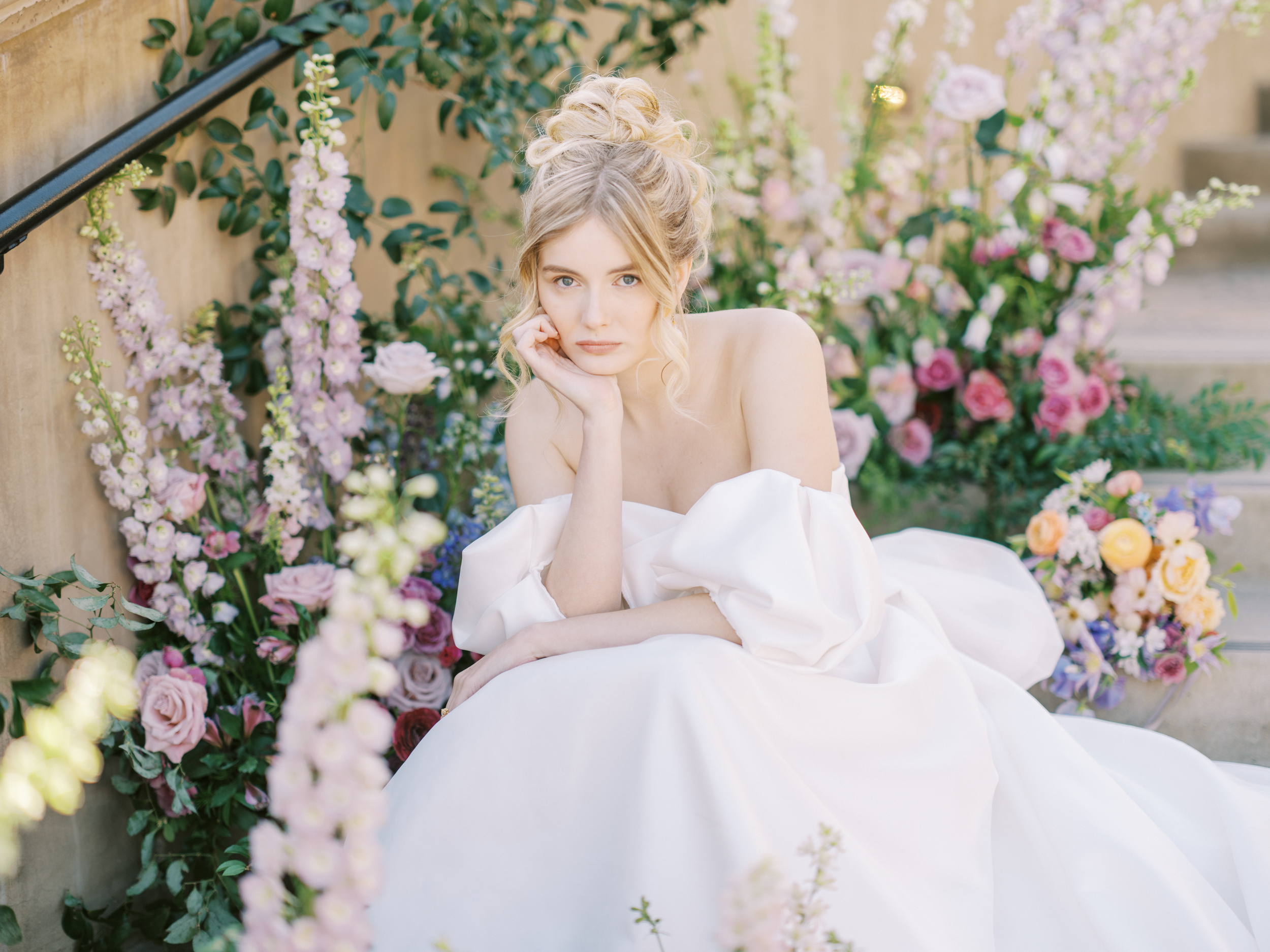 bride sitting in flowers