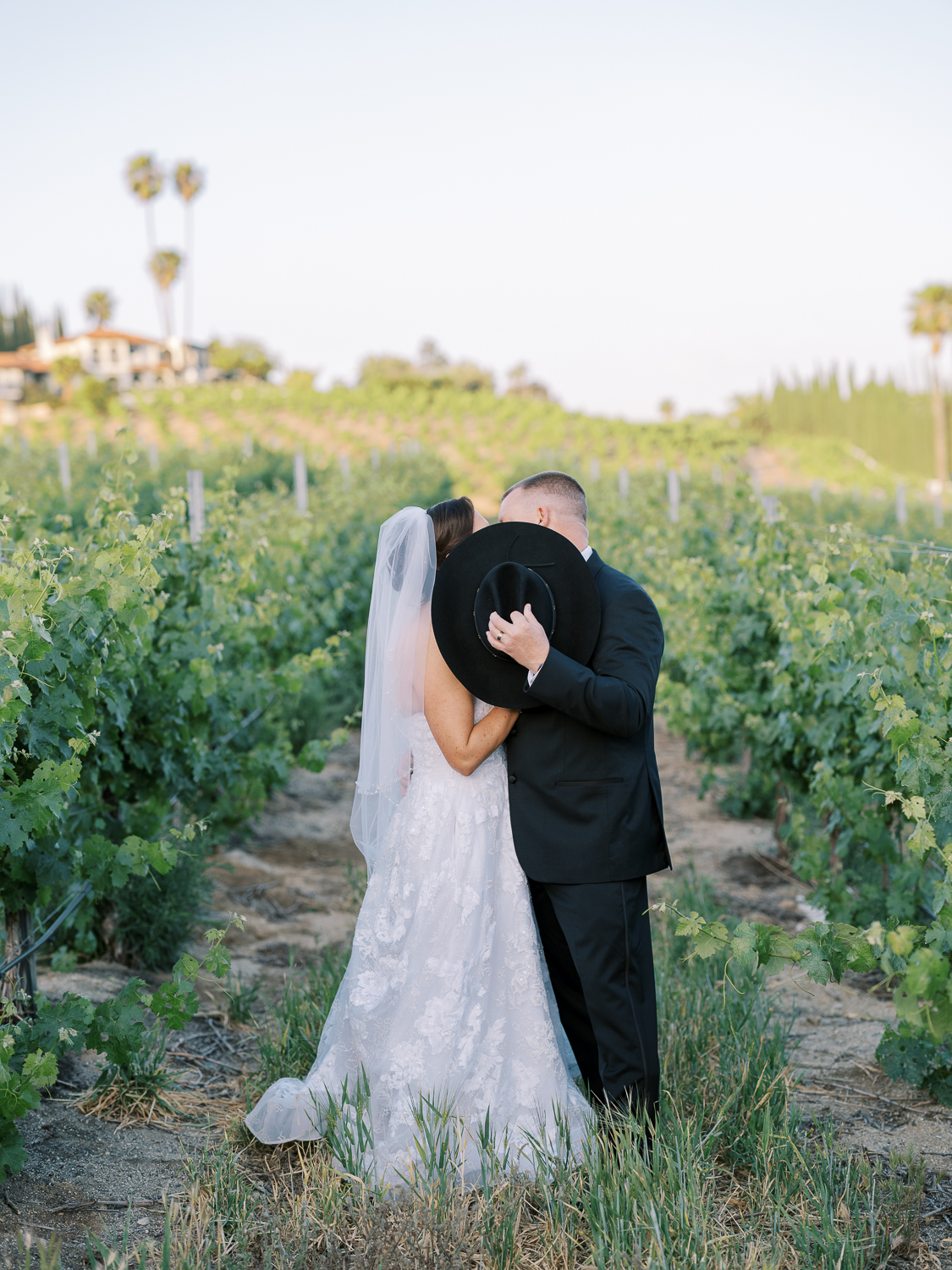 Rustic groom style with black cowboy hat and suit
