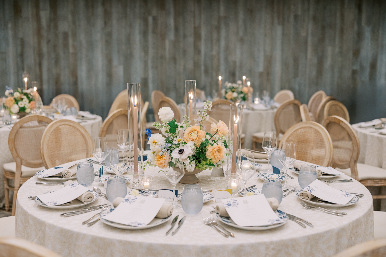 Candlelit tablescape with ivory linens and romantic floral centerpieces in neutral tones