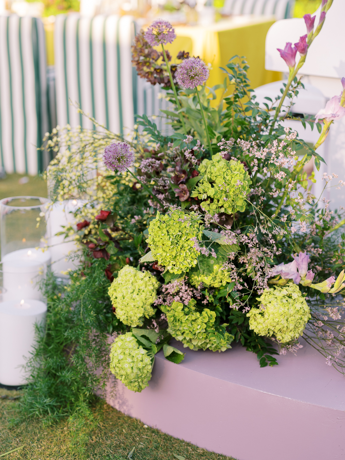 Large floral centerpieces sit on a purple stage for the pianist at Lakehouse Resort San Marcos 