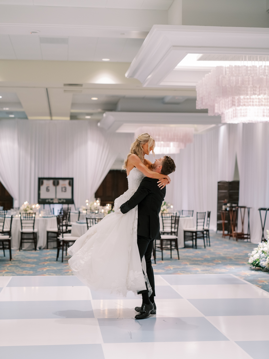 The newlyweds take a spin on the custom blue and white dance floor in the Sunset Ballroom at Paradise Point Resort