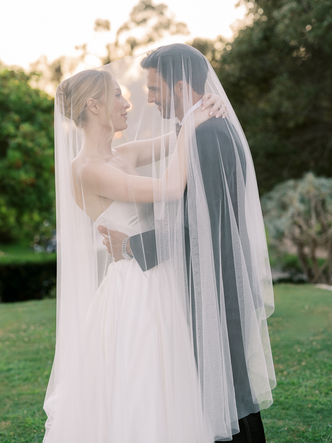 Bride and groom sunset portrait under the veil at Rancho Valencia