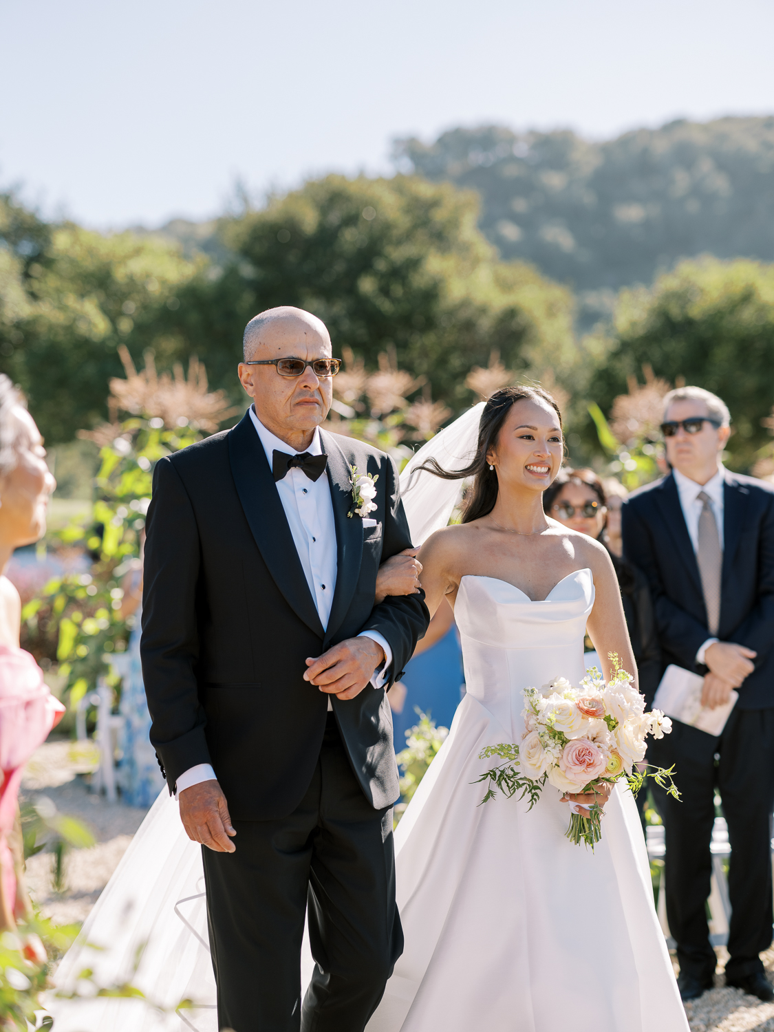 The bride and her father enter the ceremony at Carmel Valley Ranch
