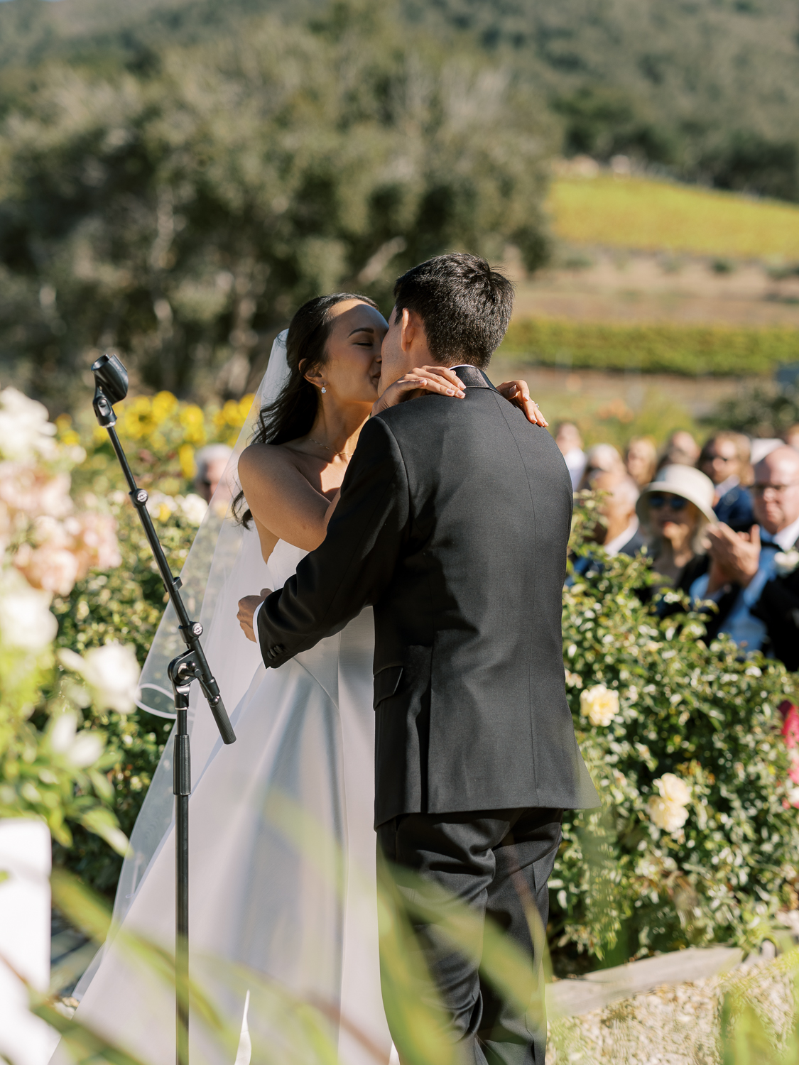 The bride and groom share a kiss at their Carmel Valley Ranch wedding ceremony