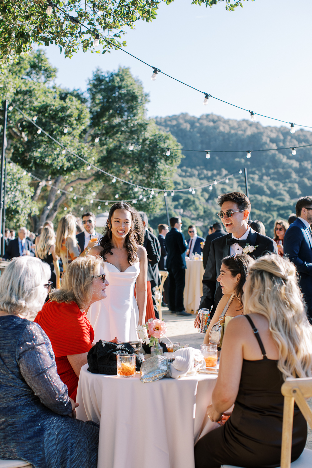 Bride and groom enjoy cocktail hour at Harvest Landing Carmel Valley Ranch with their guests