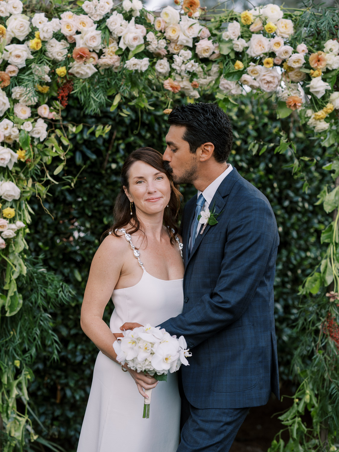 the groom kisses the bride at their del mar wedding