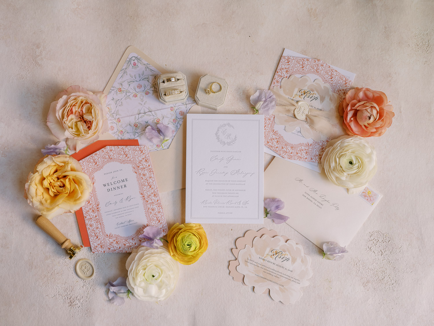 colorful invitation suite with wedding rings at rancho valencia