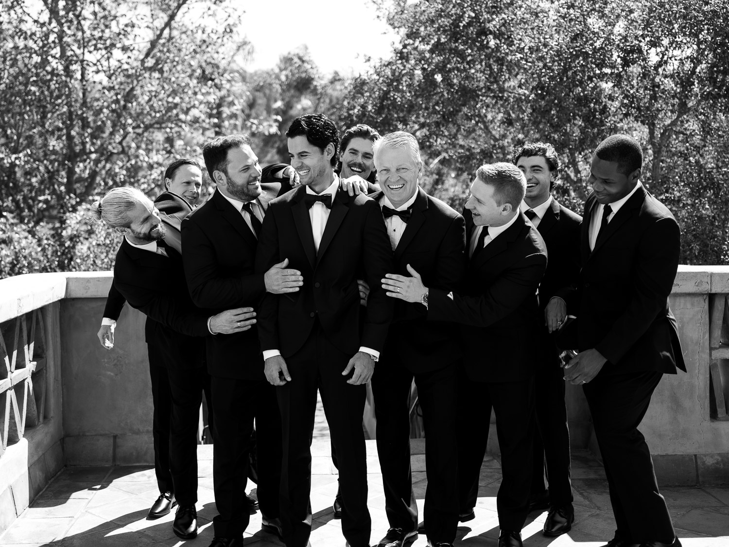 groomsmen sharing a laugh at rancho valencia terrace patio