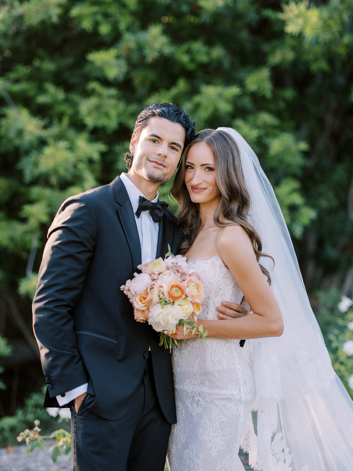 bride and groom portrait with colorful wedding bouquet at rancho valencia