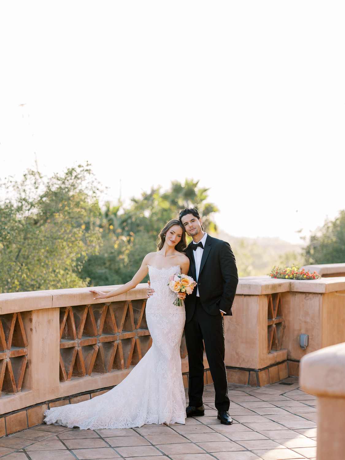 romantic photos on rancho valencia terrace with colorful wedding bouquet