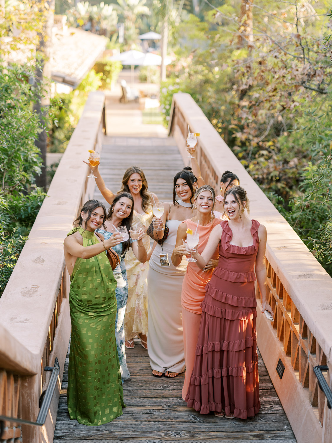 bridesmaids and friends sharing a laugh on rancho valencia bridge